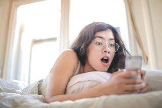 woman-lying-on-bed-holding-smartphone-3807535.jpg